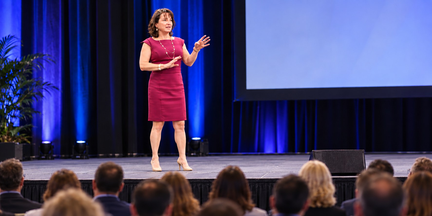 Anna Conrad delivering a keynote on stage