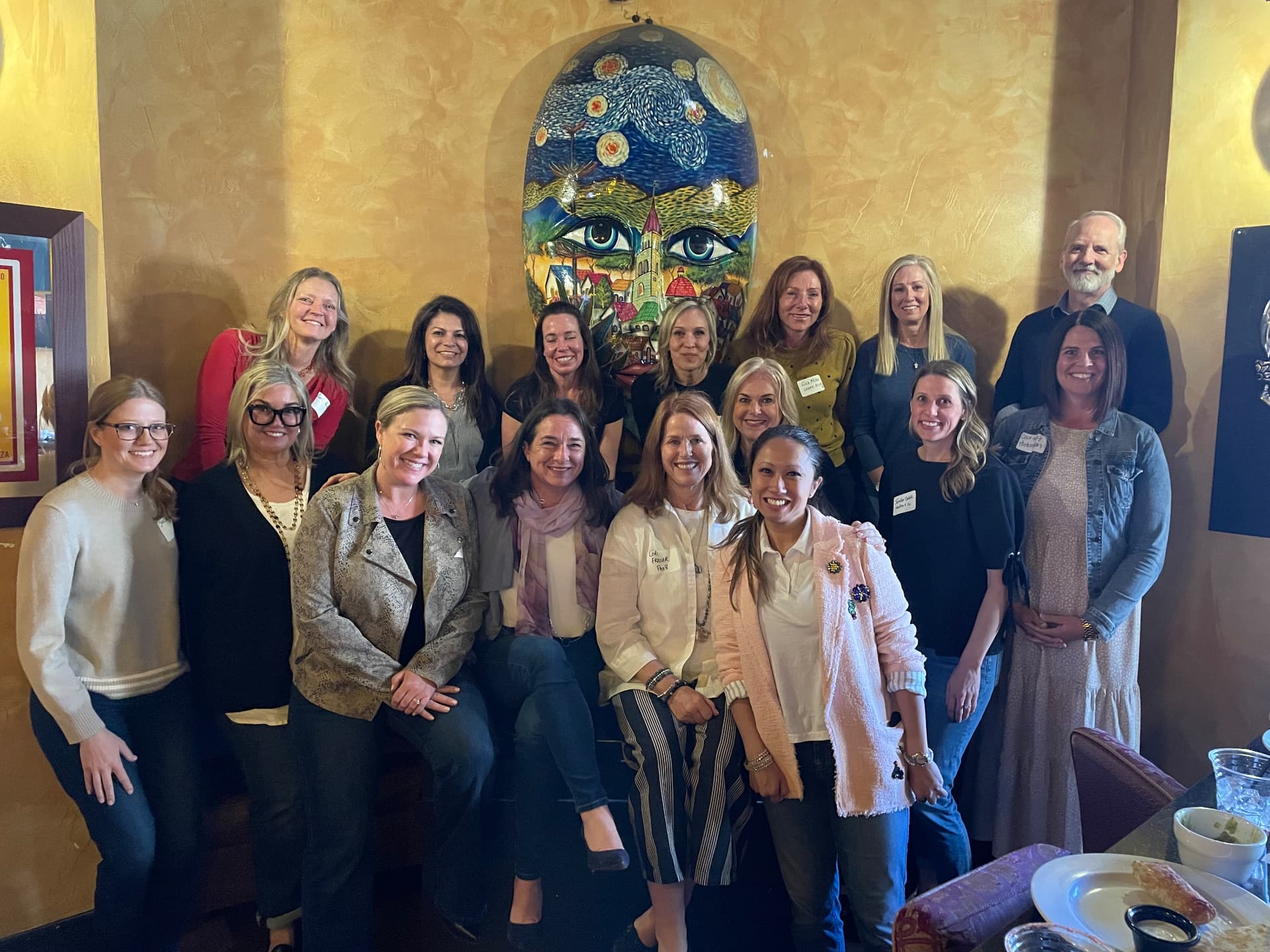 Roundtable members grouped together at an in-person happy hour gathering