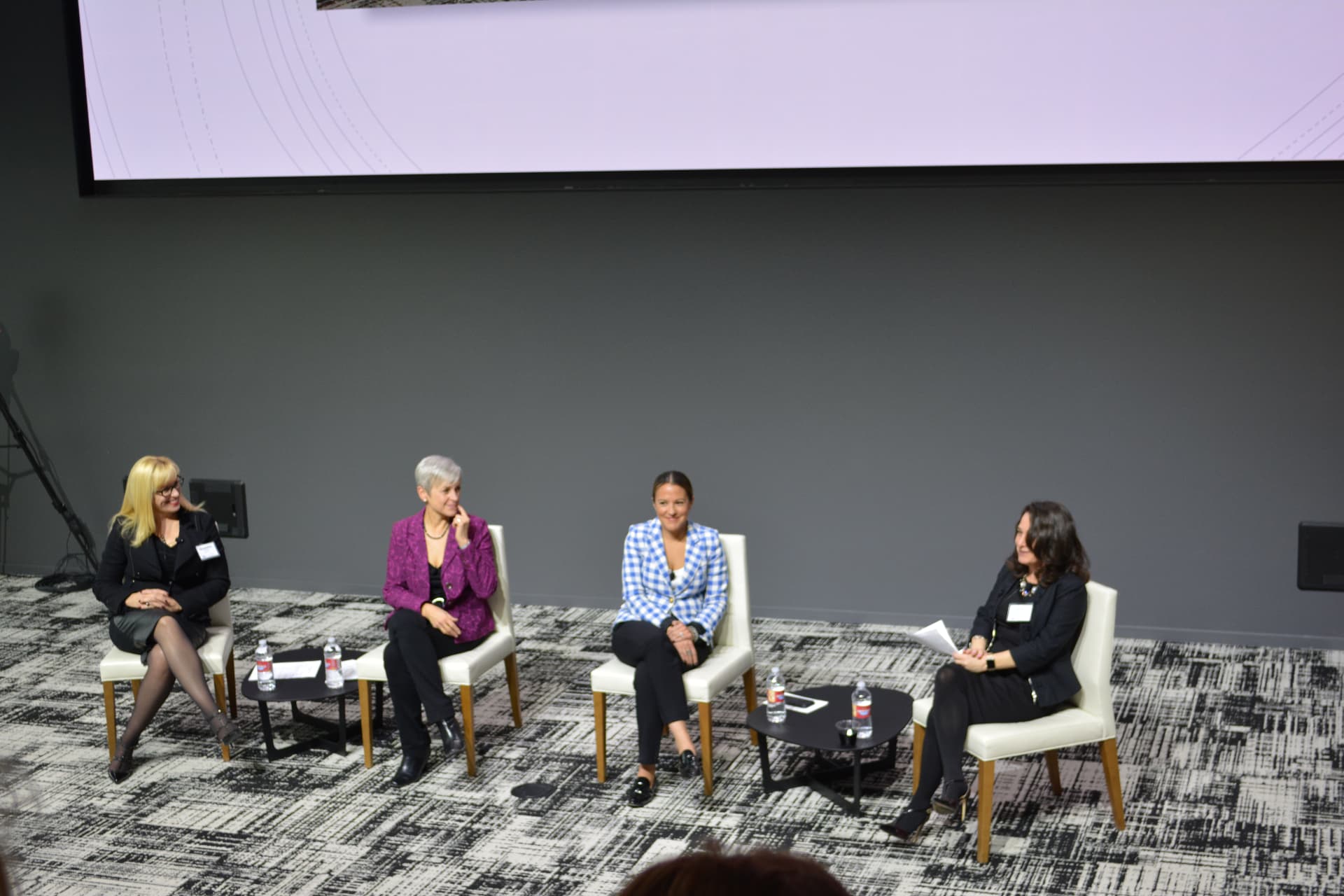 Four women participating in an Executive Voices panel conversation