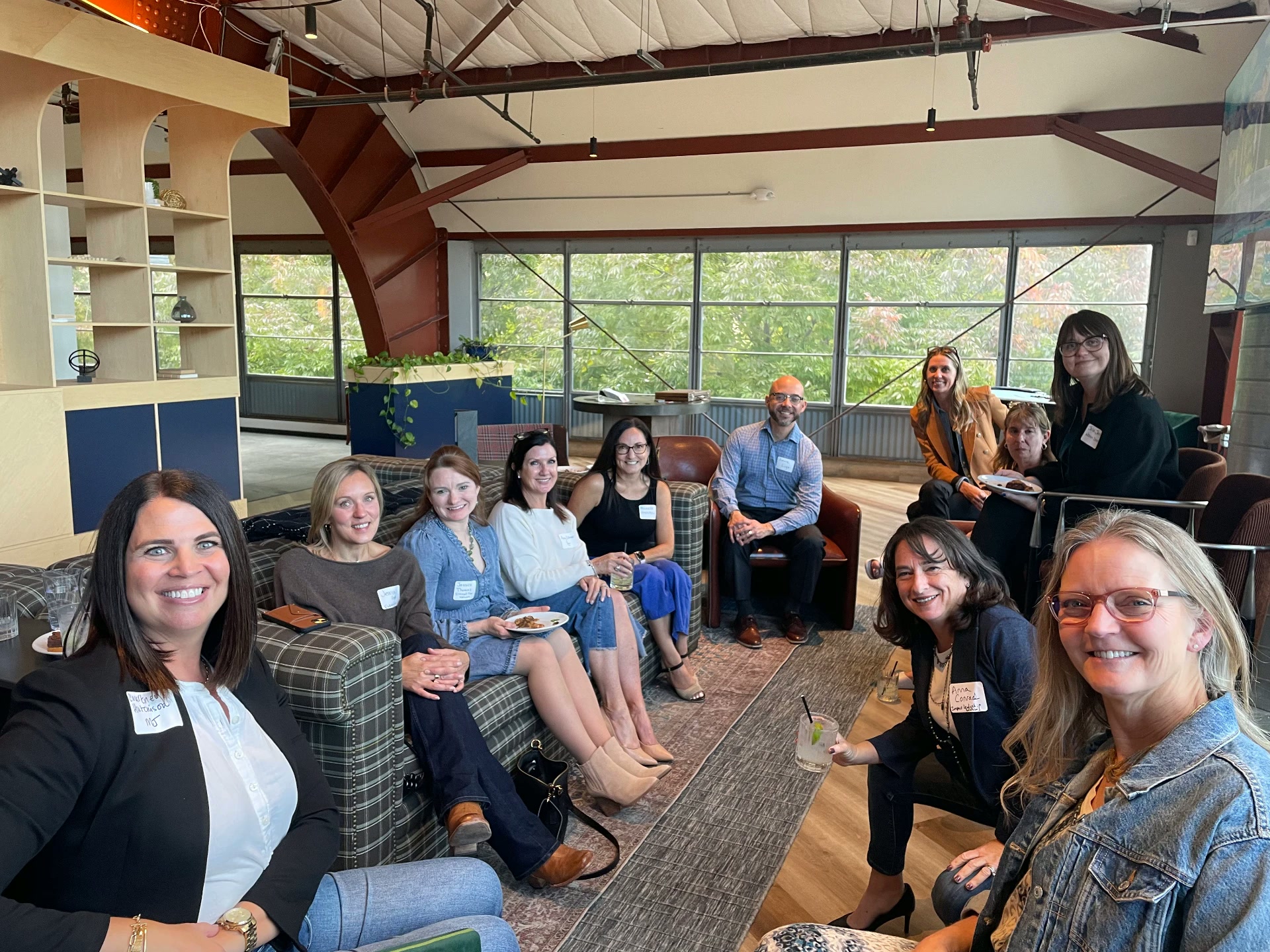 Roundtable members gathered for a happy hour conversation in a bright loft space